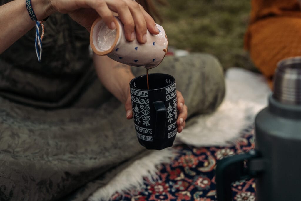 Ritual im Frauenkreis in der Oberpfalz – Frau gießt Tee als Symbol für Achtsamkeit und Verbindung